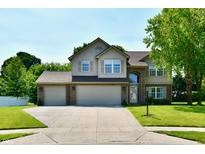 Charming two-story home with a three-car garage and a well-manicured lawn at 10519 Hyacinth Ct, Noblesville, IN 46060