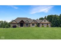 Charming brick home featuring a large front lawn, complemented by a well-manicured landscape and natural accents at 1412 10Th St, Danville, IN 46122