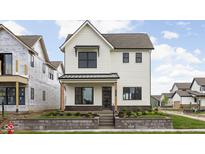 Charming two-story home with a white exterior, landscaped front yard, and covered porch at 1654 Fernley Dr, Westfield, IN 46074