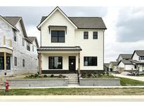 Charming two-story home boasts a modern farmhouse design and welcoming curb appeal with landscaped front yard at 1654 Fernley Dr, Westfield, IN 46074