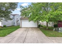 Charming home featuring a two-car garage, neutral siding and mature trees at 2270 Collins Way, Greenfield, IN 46140