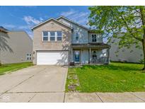 Charming two-story home with a well-maintained front lawn and attached two-car garage at 3362 Pavetto Ln, Indianapolis, IN 46203