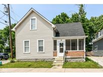 Charming two-story home with a screened-in porch and classic architectural details on a well-maintained lot at 352 W 28Th St, Indianapolis, IN 46208