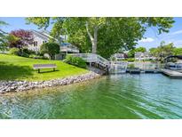 Beautiful waterfront home with dock, bench, and lake views at 3532 Clearwater Cir, Indianapolis, IN 46240