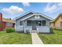 Charming bungalow featuring a cozy front porch, landscaped yard, and well-maintained exterior in a residential neighborhood at 3906 Fletcher Ave, Indianapolis, IN 46203
