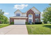 Charming two-story home with brick and siding, manicured lawn, and a convenient two-car garage at 4017 Ivory Ct, Carmel, IN 46074