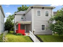 Charming two-story home featuring a red-brick porch, gray siding, and a well-maintained lawn at 4923 E University Ave, Indianapolis, IN 46201