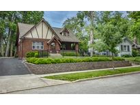 Charming Tudor-style home with brick facade, manicured landscaping, and inviting curb appeal at 5024 N Kenwood Ave, Indianapolis, IN 46208