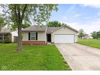 Charming single-story home with a well-maintained lawn and two-car garage at 6227 Long River Ln, Indianapolis, IN 46221