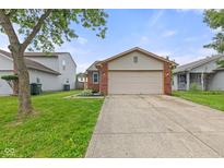 Charming one-story home with a well-maintained lawn and inviting two-car garage at 6332 Long River Ln, Indianapolis, IN 46221