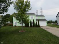 Charming two-story home with a well-manicured lawn and a tree-lined front yard at 6714 Colleens Way, Indianapolis, IN 46221