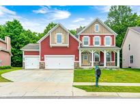 Charming two-story home featuring a well-manicured lawn and a spacious three-car garage at 749 Bracknell Dr, Avon, IN 46123