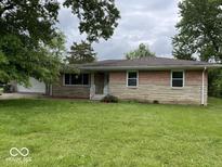 Charming single-story home featuring a stone and brick facade and a well-manicured front lawn at 8045 Briarwood Dr, Indianapolis, IN 46227