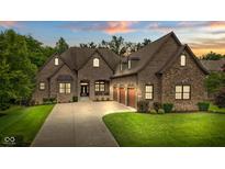 Beautiful two-story brick home with a three-car garage and well-manicured lawn at 11393 Muirfield Trce, Fishers, IN 46037
