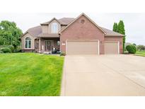 Inviting two-story home featuring a brick facade, attached two-car garage, and well-manicured front lawn at 1145 Forest Commons Dr, Avon, IN 46123