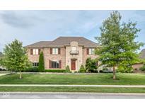 Stunning brick home featuring manicured lawn, stone accents, and beautiful curb appeal at 13429 Boxelder Ct, Carmel, IN 46074