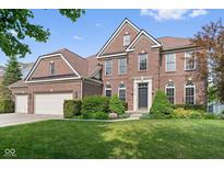 Beautiful two-story brick home featuring a well-manicured lawn and a two-car garage at 15515 Alameda Pl, Westfield, IN 46074