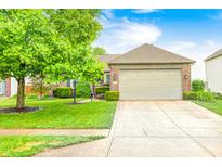 Charming single-story home with brick facade, mature landscaping, and an attached two-car garage at 1630 Eastfork Dr, Brownsburg, IN 46112