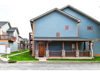 Charming blue two-story home with inviting porch and stone accents. Houses in the distance at 1635 N College Ave # 4, Indianapolis, IN 46202