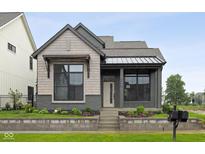 Charming home featuring a mixed material facade, inviting entrance, and professionally landscaped yard at 1663 Fernley Dr, Westfield, IN 46074