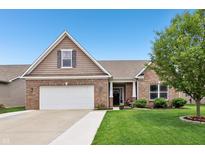 Charming brick home with a well-maintained lawn, two car garage and appealing curb appeal at 1893 Devonshire Ave, Avon, IN 46123