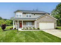 Charming two-story home with a welcoming front porch and manicured lawn at 19187 Outer Bank Rd, Noblesville, IN 46062