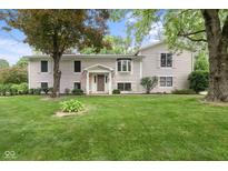Charming two-story home with a manicured lawn and mature trees at 233 Saddlebrook Dr, Zionsville, IN 46077