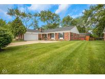 Charming brick home with a well-manicured lawn and mature trees at 3148 Arbutus Dr, Indianapolis, IN 46224