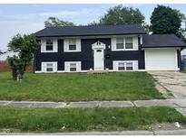 Two story home featuring a dark exterior and white shutters with an attached garage at 3949 Chateau Dr, Indianapolis, IN 46226