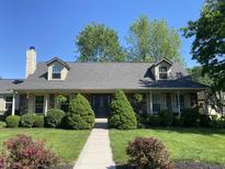 Charming brick home with well-manicured lawn, mature trees, and inviting front entrance at 47 Oakwood Ct, Brownsburg, IN 46112