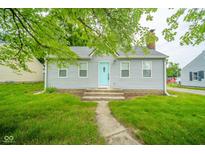 Charming single-story home with light gray siding and a welcoming turquoise front door at 5516 W Minnesota St, Indianapolis, IN 46241