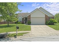 Charming brick and vinyl home featuring an attached two-car garage, landscaped lawn, and concrete driveway at 6529 Lakesedge Dr, Indianapolis, IN 46237