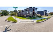Modern black home on a corner lot features professional landscaping and a sidewalk at 8695 Morgan Dr, Fishers, IN 46038