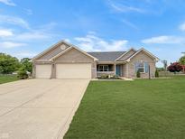 Charming single Gathering home with a well manicured lawn and a two car garage at 930 Penstock Ct, Avon, IN 46123