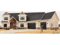 Charming two-story home with a two-car garage, stylish wooden door and modern architectural details at O Legacy Estates-Lot 5, Mooresville, IN 46158