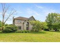 Charming two-story home with a brick facade, lush lawn and mature trees at 1120 Mill Run Overlook, Noblesville, IN 46062