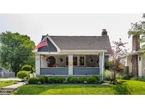 Charming home featuring a inviting front porch and manicured landscaping at 1437 Shannon Ave, Indianapolis, IN 46201