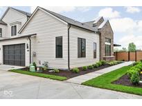 Charming home featuring sleek black window frames, a dark garage door, and a well-manicured lawn at 1677 Solebar Way, Westfield, IN 46074