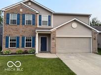 Two-story home with brick and vinyl siding, complemented by a well-maintained lawn at 1711 Jaques Dr, Lebanon, IN 46052