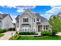 Charming two-story home with manicured lawn and beautiful landscaping on a sunny day at 2789 W High Grove Cir, Zionsville, IN 46077