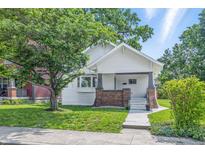 Charming home exterior with a lush front yard and inviting entrance with mature trees at 2831 N Talbott St, Indianapolis, IN 46205