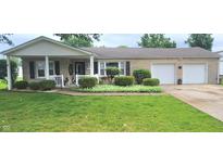 Charming ranch-style home with well-manicured lawn and stone exterior at 3039 28Th St, Columbus, IN 47203