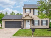 Charming two-story home featuring a well-kept lawn, attached garage, and neutral siding at 3734 Lacebark Dr, Indianapolis, IN 46235