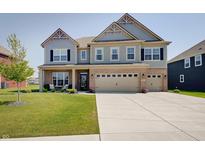 Charming two-story home with a well-manicured lawn, a welcoming front porch, and a convenient three-car garage at 4163 Ironclad Dr, Bargersville, IN 46106