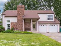 Charming two-story home with an attached two-car garage and brick chimney at 4382 Castlebay Way, Indianapolis, IN 46254
