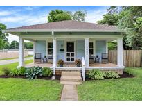 Charming home with a cozy covered front porch and well-maintained landscaping at 4641 Crittenden Ave, Indianapolis, IN 46205