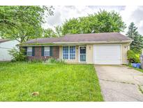 Ranch home featuring brick and siding exterior, an attached garage and a front yard at 5401 Padre Ln, Indianapolis, IN 46237