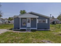 Charming single story home with a small front yard and blue siding and a decorative covered porch at 5515 W Morris St, Indianapolis, IN 46241
