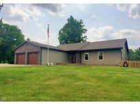 Charming single-story home with a two-car garage and well-maintained front lawn, perfect for outdoor activities at 600 Old Moore Rd, Martinsville, IN 46151