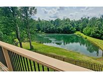 Picturesque pond view from a deck, surrounded by lush greenery and mature trees, offering a serene escape at 600 Old Moore Rd, Martinsville, IN 46151